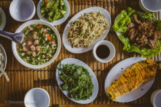 An afternoon feast of vegetables, fruit, noodles, meat and fish prepared by a local family in Mai Chau. Vietnam, February 2014.